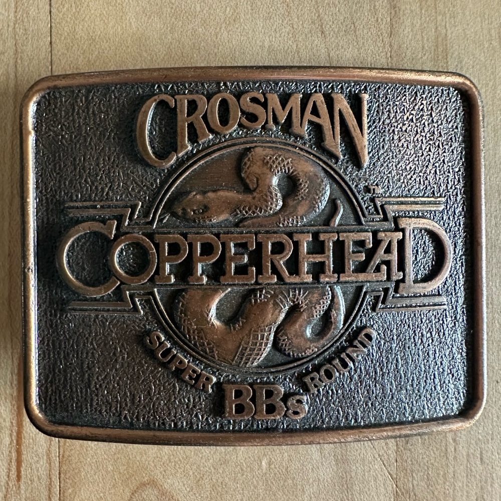 VINTAGE 1970'S EUC CROSMAN COPPERHEAD SUPER ROUND BB'S BELT BUCKLE 2 3/4”x2 1/4”